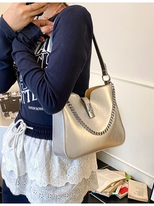 Minimalist silver bucket shoulder bag with metallic chain strap and U-shaped opening