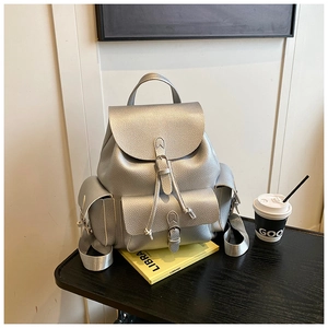 Detail of silver lychee grain leather backpack with buckle straps and side flap pockets