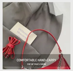 Detail of red faux leather hobo bag with silver chain and detachable shoulder strap
