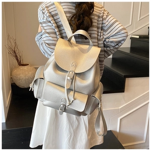 Silver pebble-textured leather backpack with buckle detail and wide fabric shoulder straps