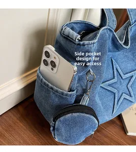 Detail of blue denim tote side pocket for smartphone storage with star embossed pattern