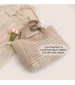Detail of woven straw tote bag texture with wide fabric strap on soft linen background
