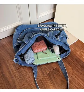 Detail shot of the spacious interior of this blue denim tote bag with contrast stitching