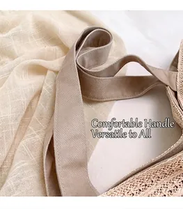 Close-up detail of woven straw tote bag featuring soft canvas handle and fine texture