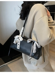 Minimalist black faux leather crossbody bag with white lace trim and heart pendant