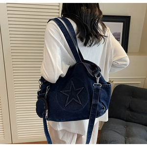 Détail de l'étoile en relief et de la petite pochette sur le sac fourre-tout en denim