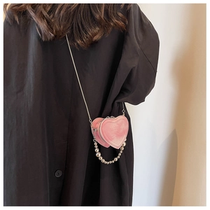 Pink heart-shaped mini crossbody bag with silver chain strap and beaded handle detail