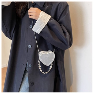 Silver heart-shaped mini crossbody bag with embossed lettering and beaded chain strap