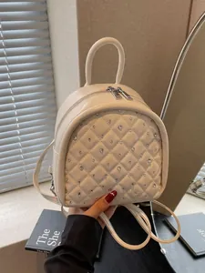 Quilted cream mini backpack for women featuring crystal studs and elegant top handle
