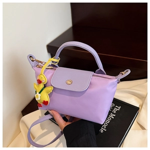 Detail of lavender mini crossbody bag with gold snap buckle and yellow duck charm