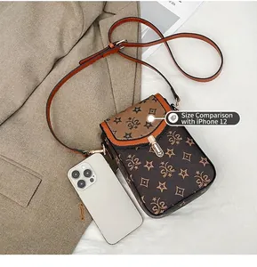 Compact vintage crossbody phone bag shown with iPhone 12 Pro for size comparison