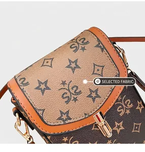 Close-up of vintage monogram crossbody bag with pebble texture and gold turn-lock closure