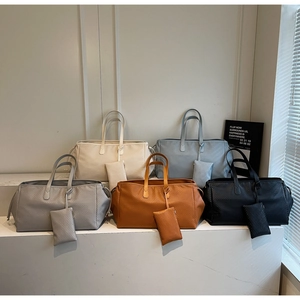 Détail de sacs cabas tissés en cinq couleurs avec leurs porte-monnaie assortis