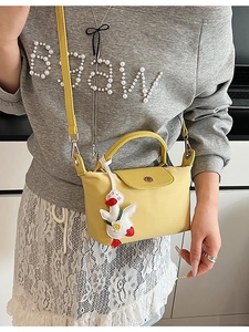 Yellow nylon handbag with brown leather flap and cute duck charm for women