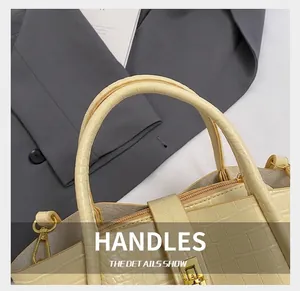 Close-up of cream white bucket bag with crocodile texture and golden clasp detail