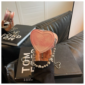 Pink heart-shaped mini leather bag with silver bead chain and zip closure detail