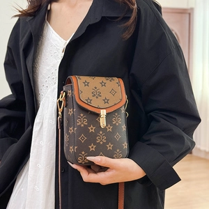 Detail of retro mini crossbody phone bag with vintage star pattern and gold clasp