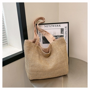 Close-up of woven tote bag texture and fabric handle on a minimalist round table