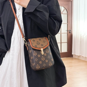 Detail view of vintage patterned mini crossbody bag with gold buckle and PU leather edge