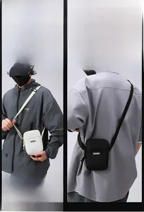 Detail view of adjustable straps on black and white crossbody phone bags by MACHUGE