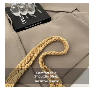 Close-up of thick woven cotton shoulder strap on a beige hollowed-out beach bag