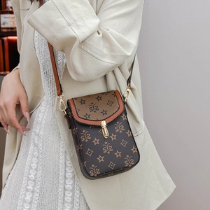 Detail showing brown pattern shoulder bag with star print and gold metal lock buckle