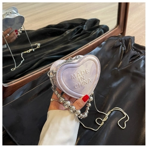 Detail of heart-shaped purple marble mini bag with metallic ball chain strap