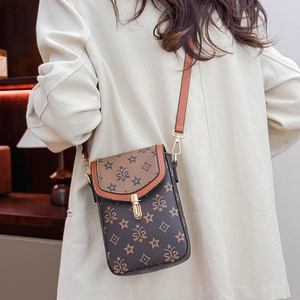 Detail of retro mini crossbody bag with star pattern and gold twist-lock on beige blazer