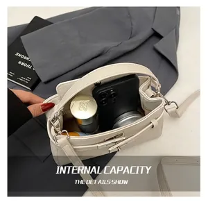 Interior storage capacity of the white litchi leather bag with daily essentials