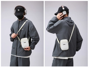 Detail view of white mini crossbody phone bag with nylon texture and adjustable shoulder strap