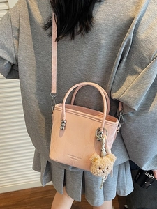 Borsa a secchiello in pelle rosa testurizzata per donna con ciondolo a orsetto