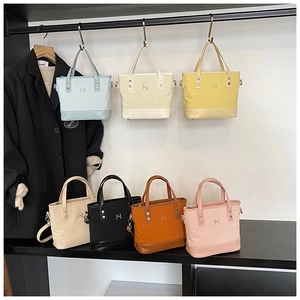 Selection of colorful canvas bucket bags in seven vibrant colors with PU leather trim