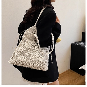 Detail of hollow out cotton crochet weave and sturdy shoulder strap on beige tote bag