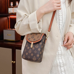 Detail of vintage brown crossbody phone bag with star print on a female model