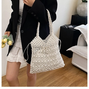 Detail of white handmade woven cotton tote bag with drawstring lining and hollow pattern
