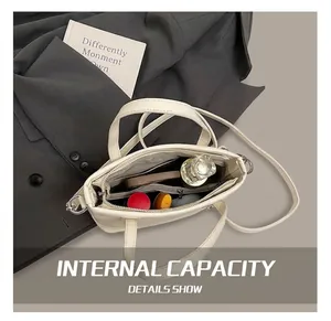 Interior view of white leather bucket bag showing compartments and spacious storage capacity