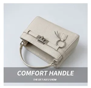 Detailed view of the off-white Kelly bag with lychee texture leather and metal lock
