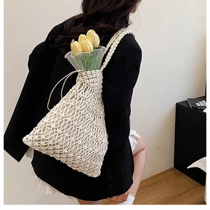Detail of hollow woven cotton mesh shoulder bag in cream with tulip floral decoration