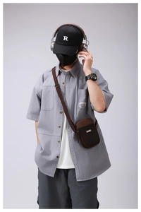 Outdoor leisure crossbody phone bag in dark brown nylon on a male model outfit