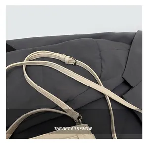 Detail of adjustable litchi texture leather shoulder strap with silver metal buckle