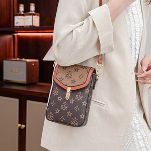 Detail of vintage crossbody phone bag with star pattern and metallic lock closure