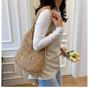 Detailed close-up of handmade hollow cotton woven shoulder bag with floral knot patterns