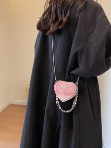 Mini pink heart-shaped crossbody bag with silver chain and bead strap detail