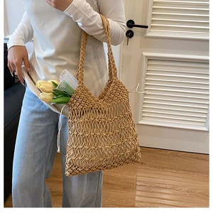 Detail of woven mesh shoulder bag with a white drawstring lining and hollow texture