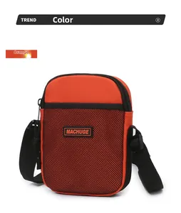 Detail of orange crossbody bag featuring black mesh pocket and adjustable strap