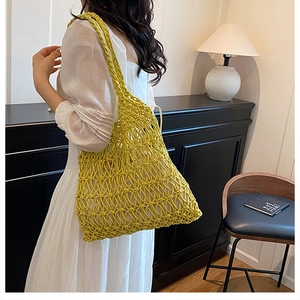 Detail of hand-crocheted hollow mesh shoulder bag in vibrant ginger yellow cotton thread