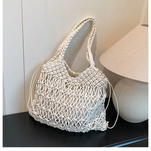Detail of hollow cotton woven beach bag with drawstring liner and bohemian texture