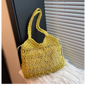 Detail of yellow hand-woven cotton shoulder bag with white drawstring inner pouch