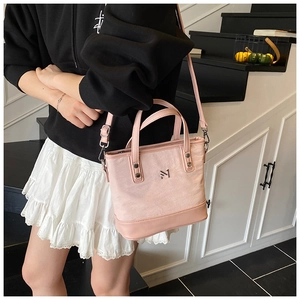 Detail of pink canvas and leather patchwork shoulder bag with adjustable strap