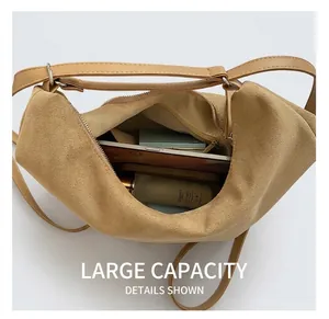 Macro shot of large capacity interior for camel suede tote bag with daily essentials